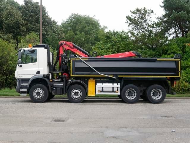 Black grab lorry with back up